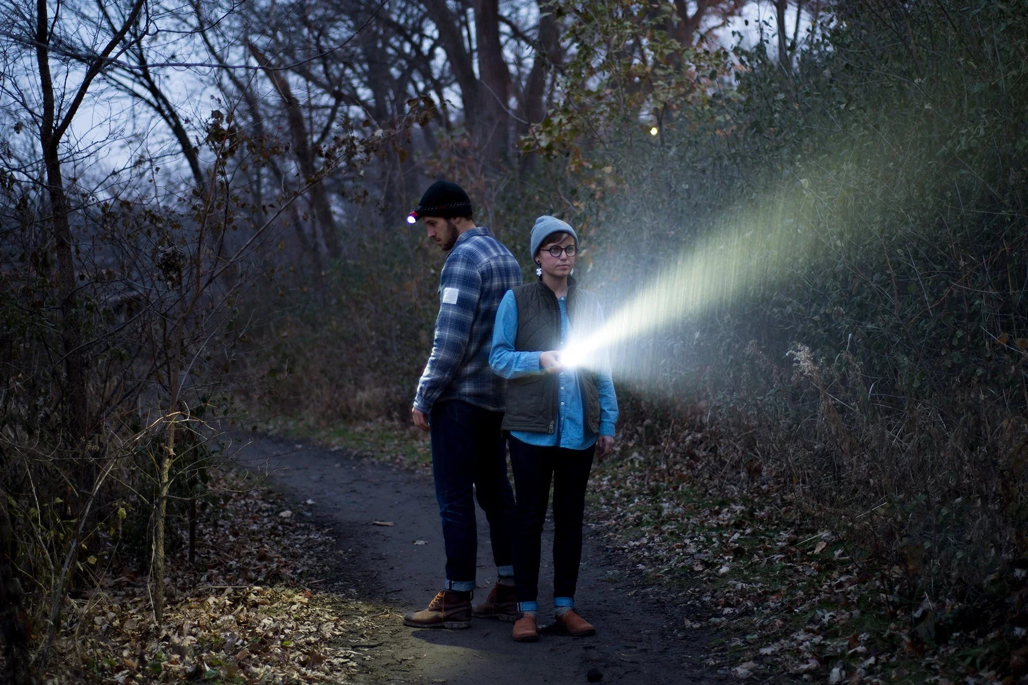 Hiker using headlamp at night on trail