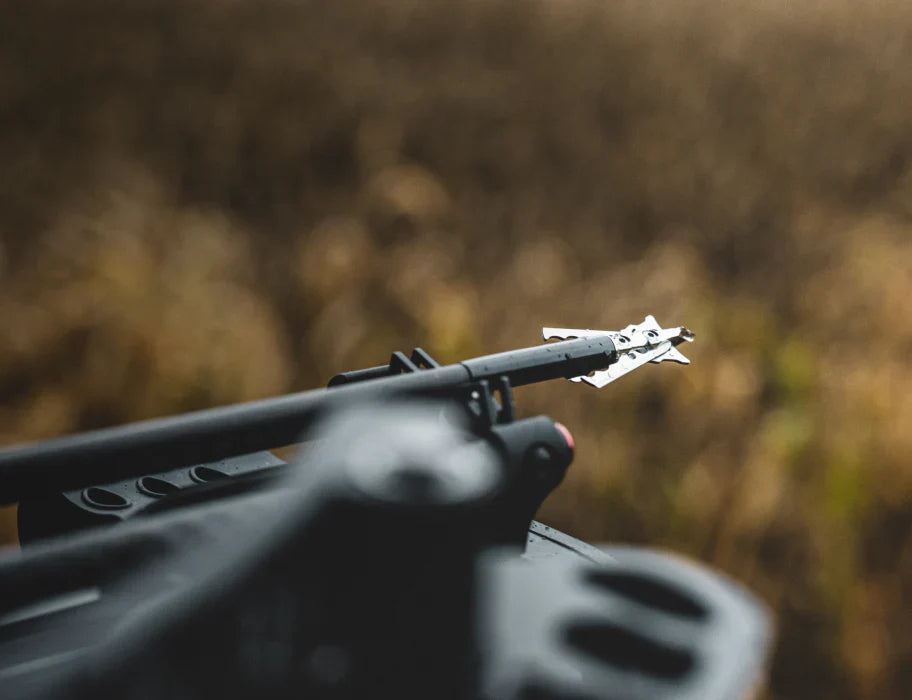 Rage Hypodermic mechanical broadhead with deployed blades beside a hunting arrow