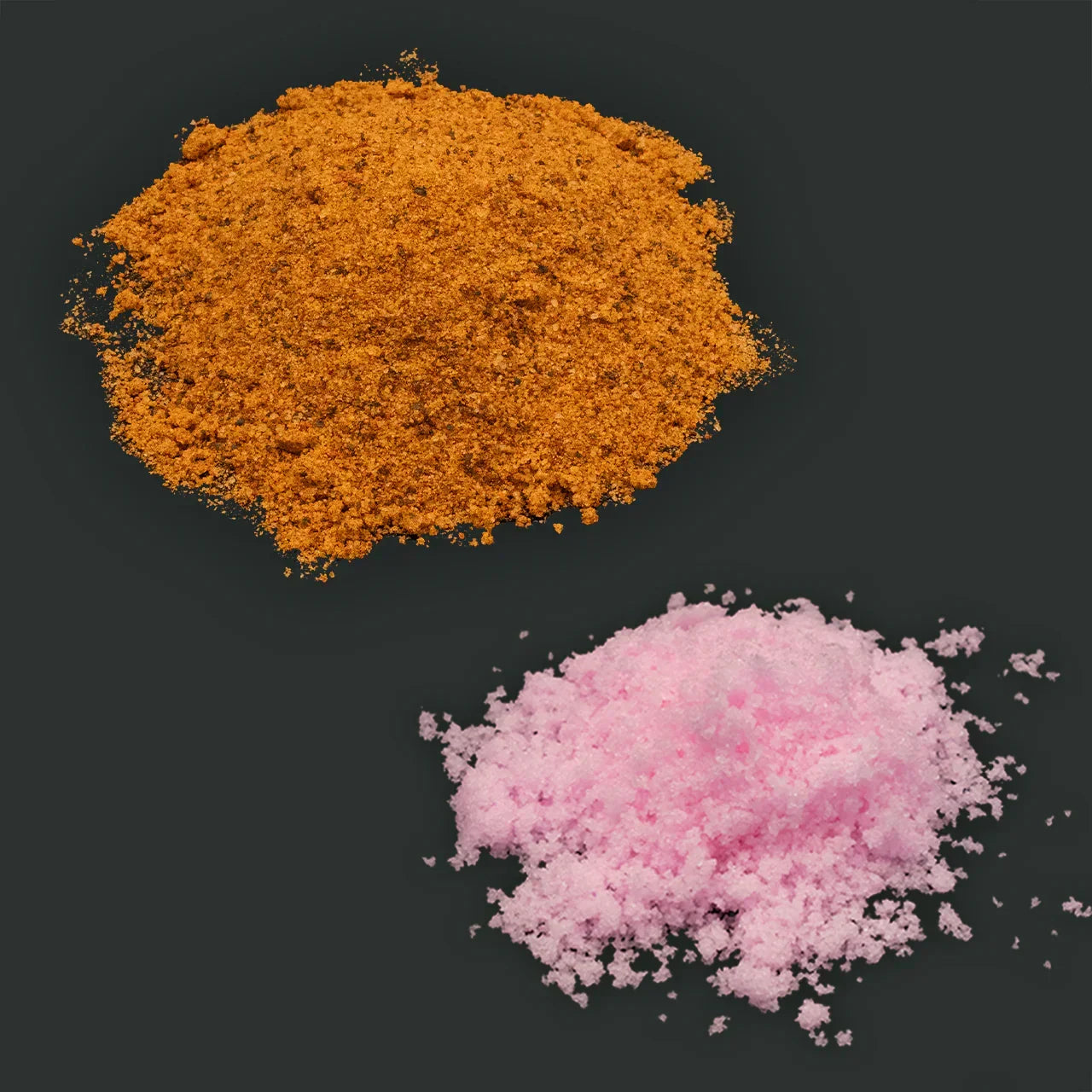 Orange jerky seasoning and pink curing salt piles on a dark background