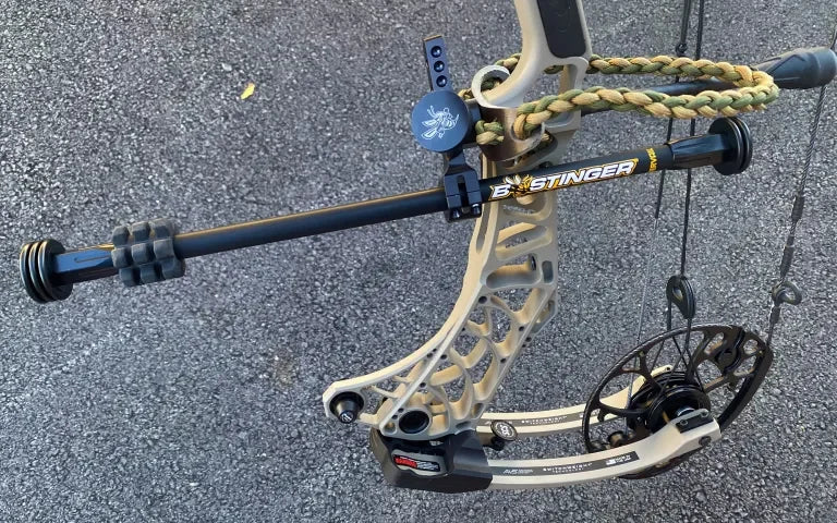 Bee Stinger Microhex Counter Slide stabilizer mounted on tan compound bow outdoors