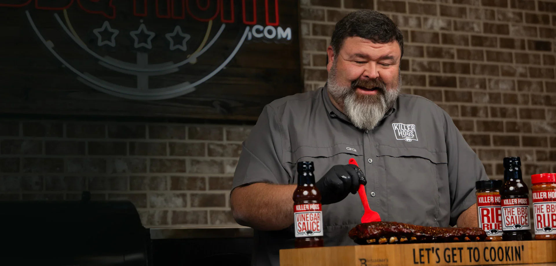Killer Hogs BBQ rubs and sauces beside smoked ribs and barbecue meats