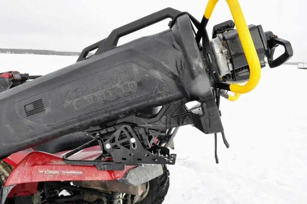 ATV with Kolpin gun case and yellow ice auger on snowy Lake of the Woods