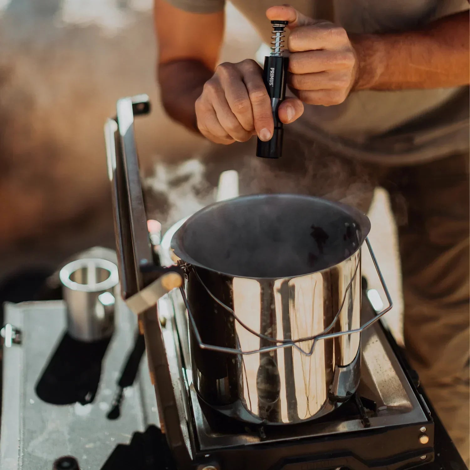 Outdoor cookware being used to prepare a meal at campsite