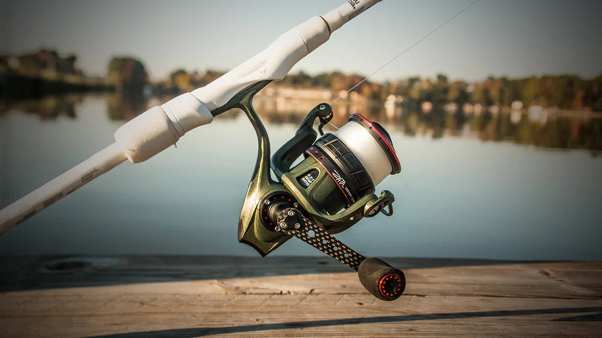 Abu Garcia Zata spinning reel on white fishing rod by a calm lake, outdoor fishing gear.