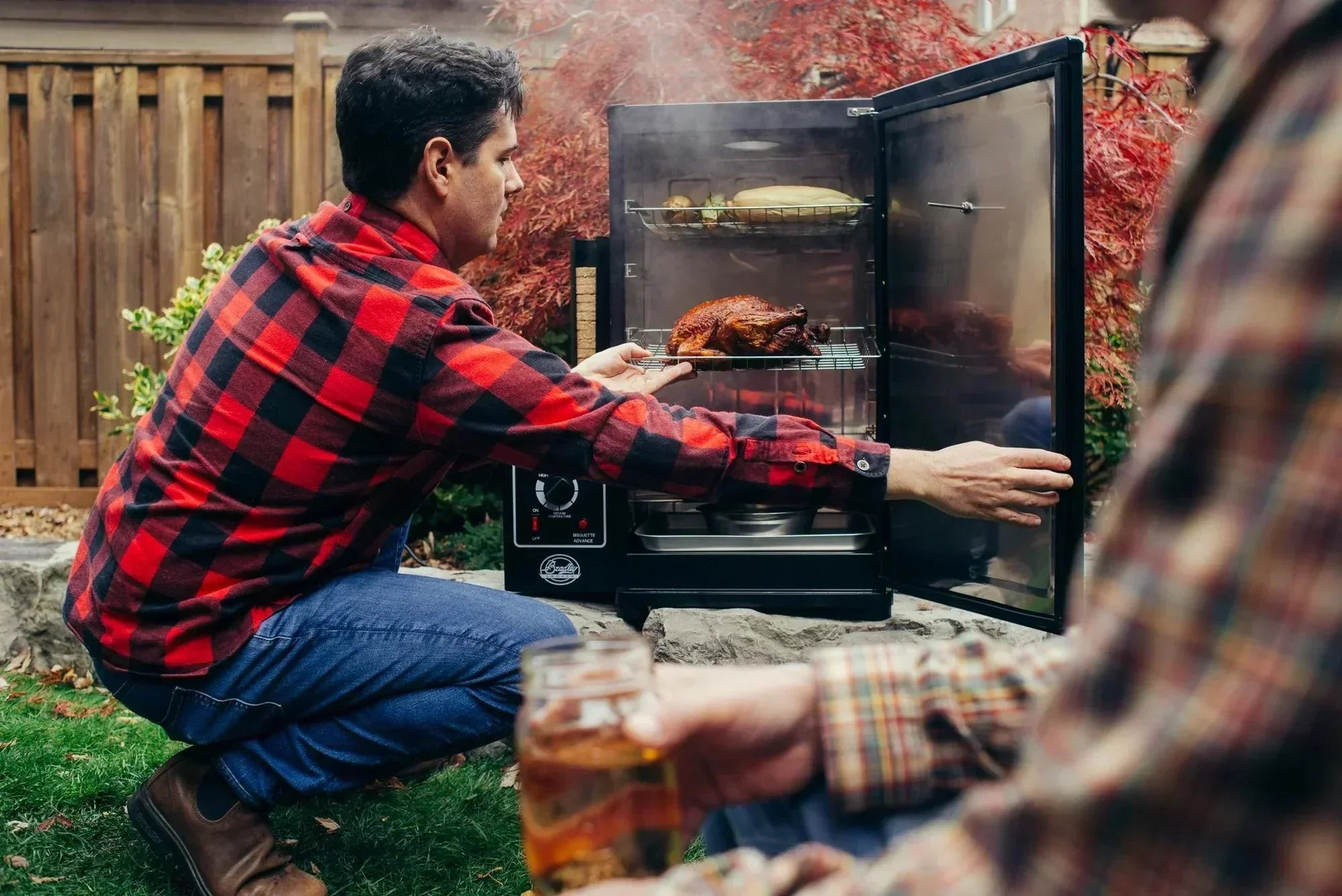 Bradley electric smoker with flavour bisquettes smoking meat outdoors
