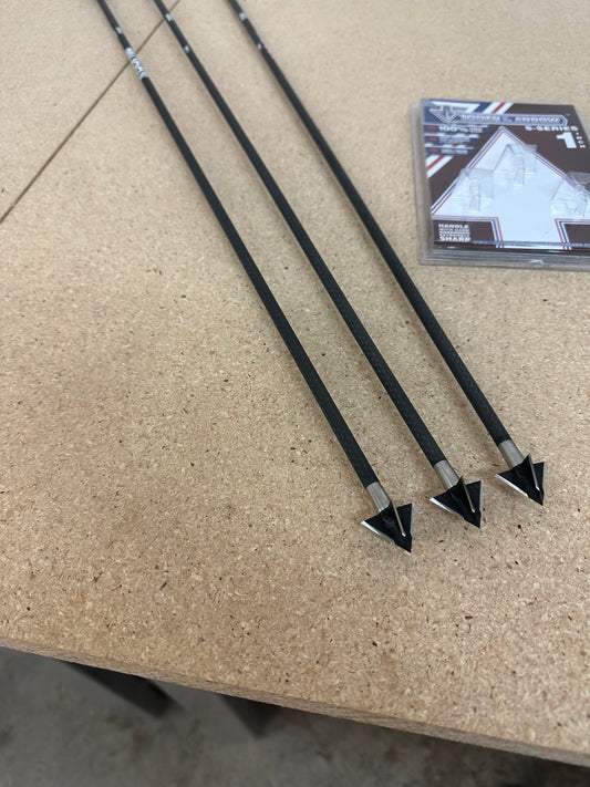 Close-up of hunting broadheads and field points on arrows, outdoor background