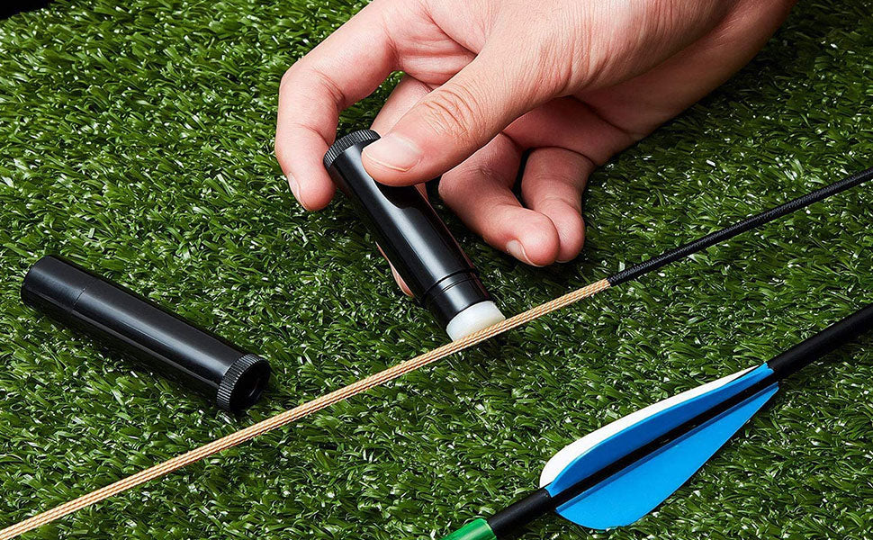 Archer applying wax and lubricant to bowstrings during maintenance