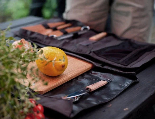 Camper using a camping knife for outdoor food prep and chores