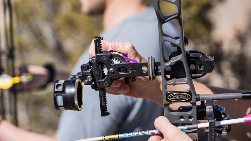 Spot Hogg archery sight mounted on a compound bow outdoors