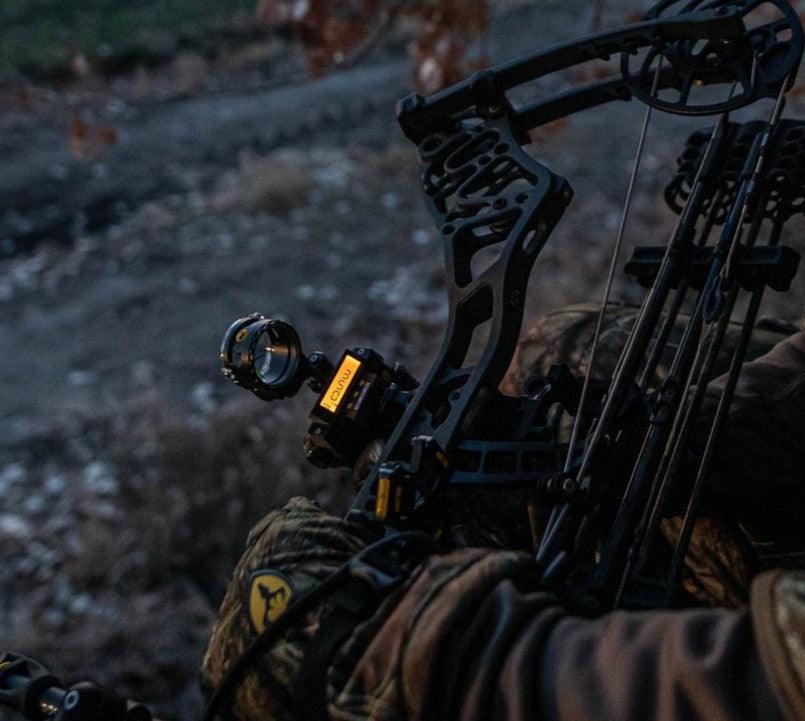 Trophy Ridge React bow sight and Whisker Biscuit arrow rest mounted on a compound bow for bowhunting