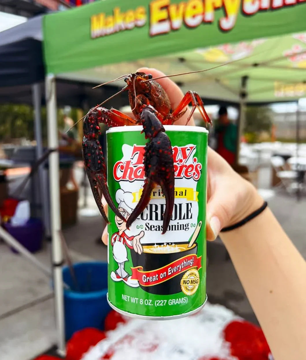 Crawfish on a can of Creole seasoning at an outdoor market or food festival