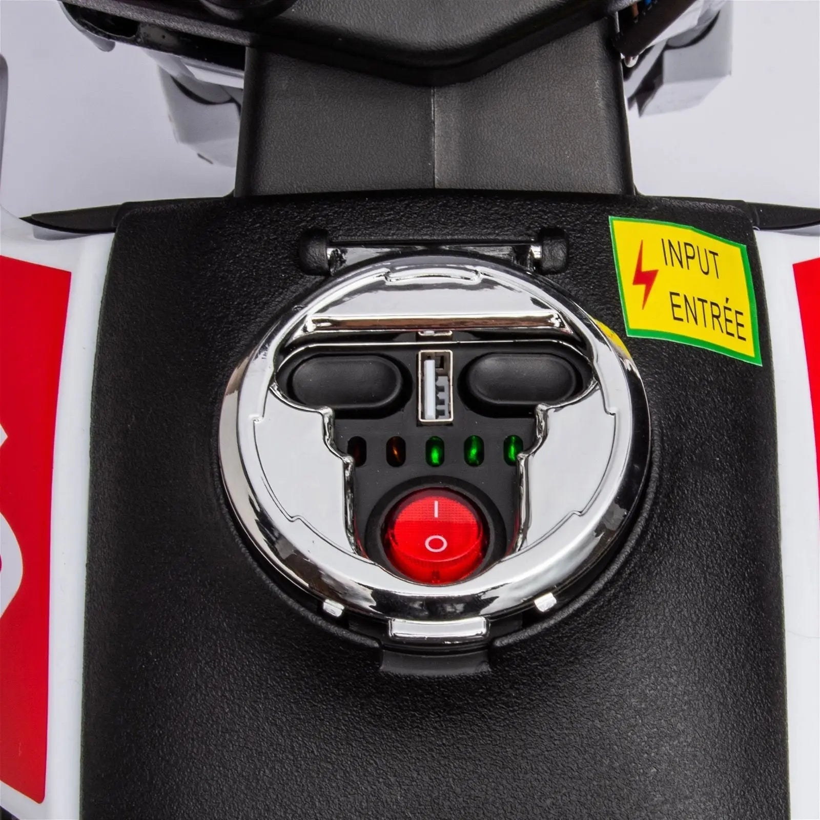 Close-up of kids ride-on motorcycle dashboard with power button and control panel.