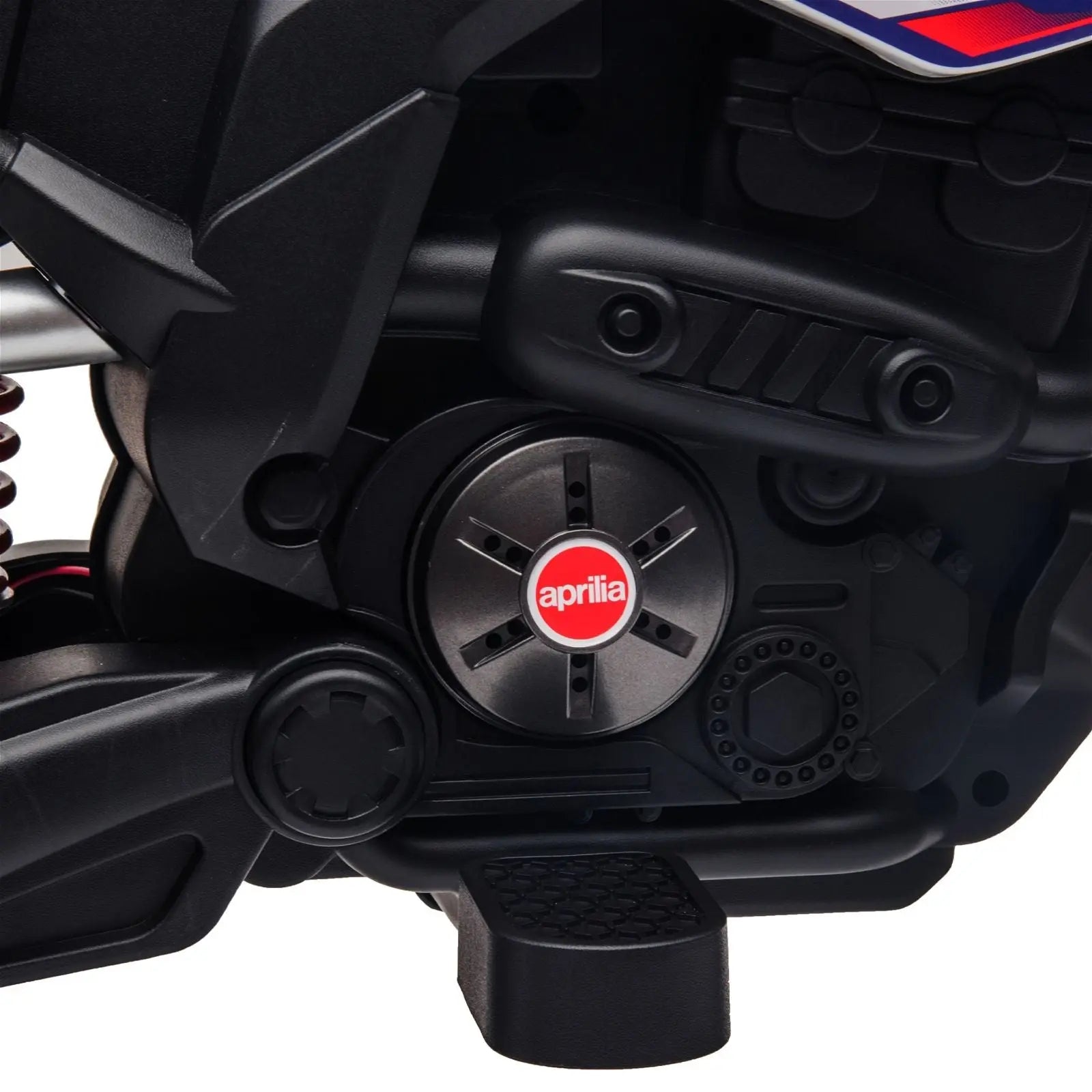 Close-up of black Aprilia kids ride-on motorcycle engine and footrest