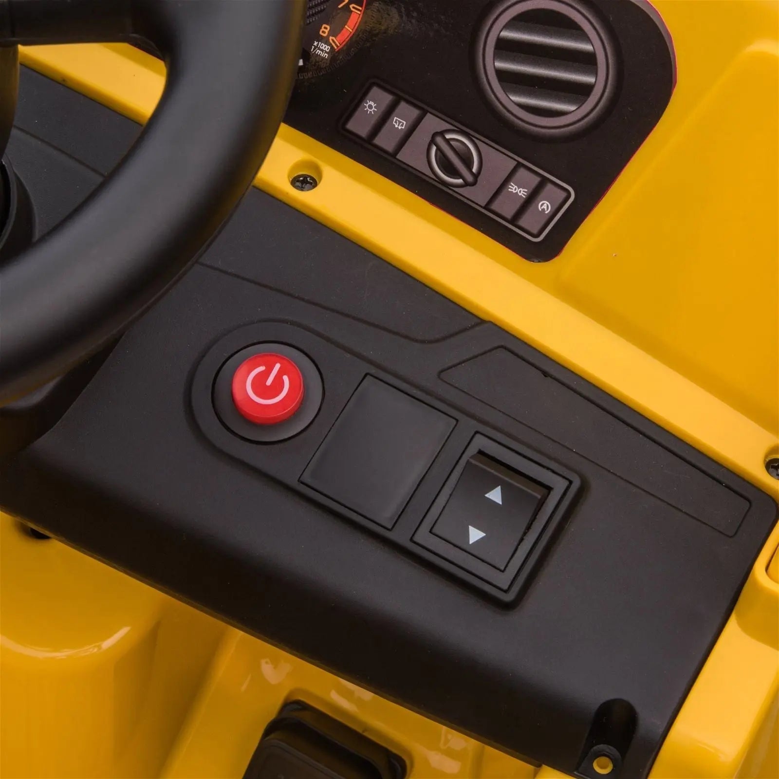 Close-up of yellow kids electric dump truck dashboard with power button and control panel