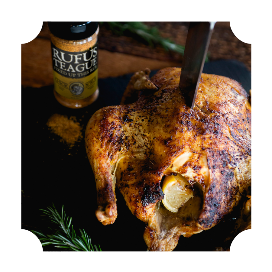 Grilled whole chicken with seasoning, lemon stuffing, and spices for outdoor cooking