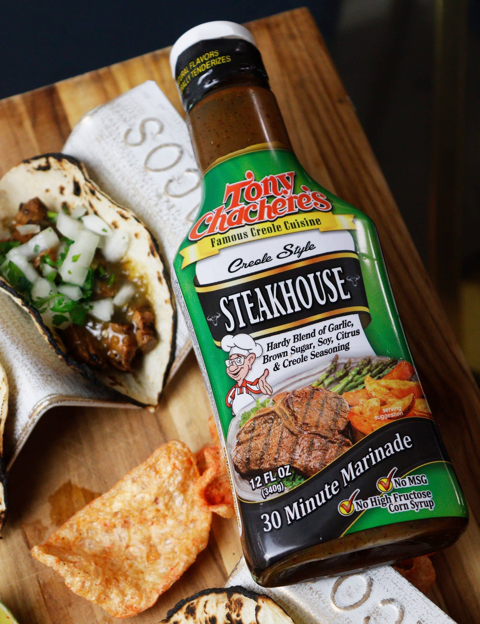 Tony Chachere's steakhouse marinade bottle on cutting board with taco and chips