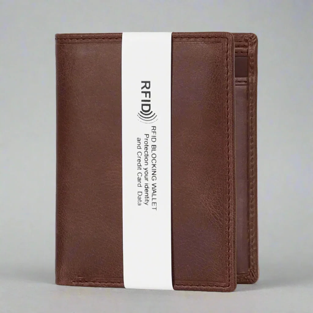 Brown leather RFID blocking wallet with white security band on neutral background
