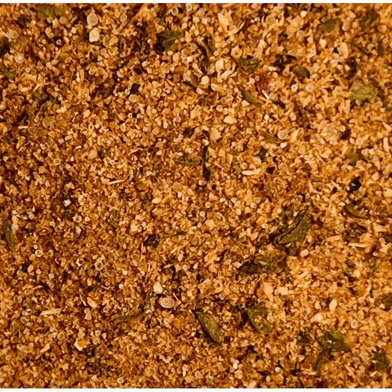 Close-up of seasoned dry spice blend with visible herbs and coarse texture