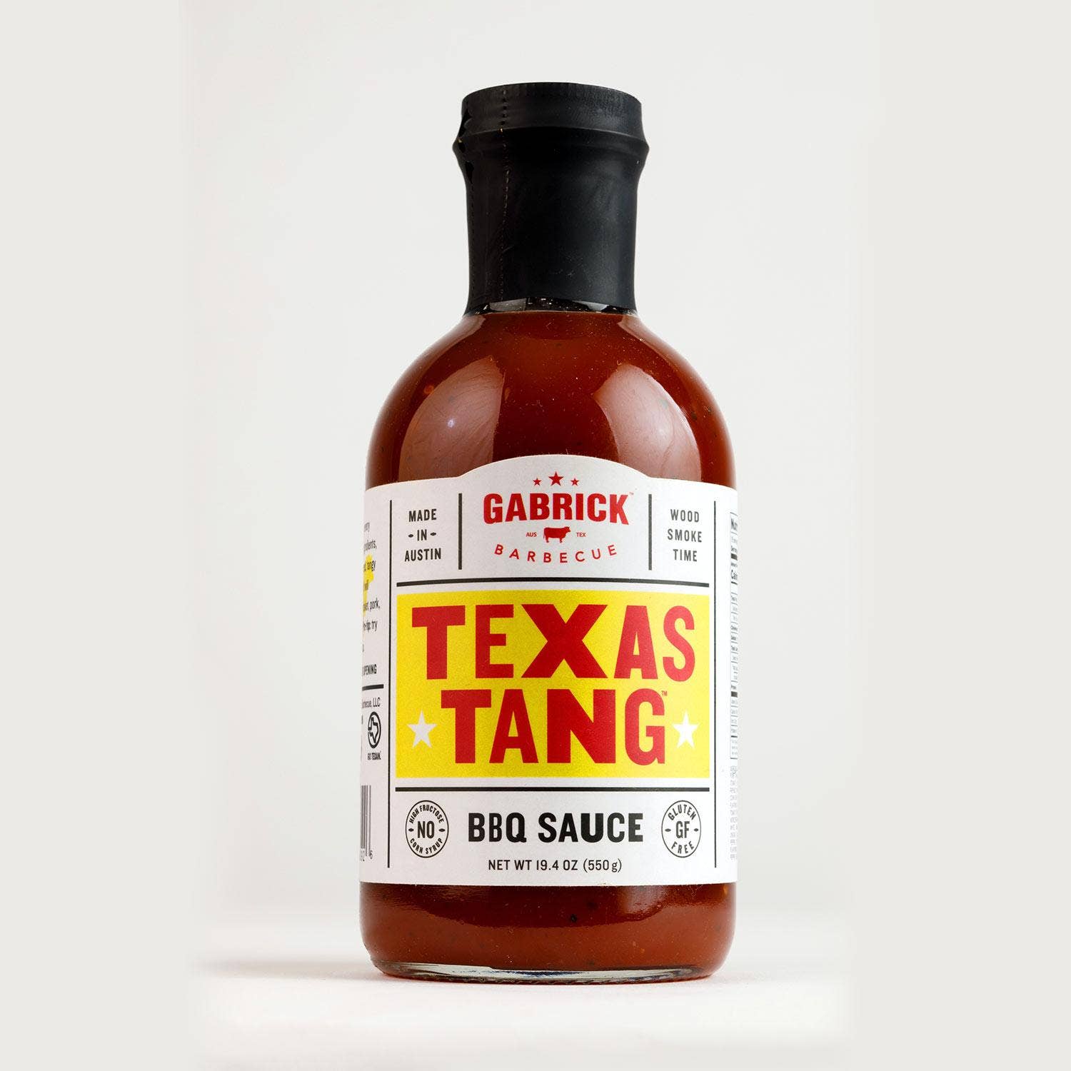Texas Tang BBQ sauce bottle with yellow and red label, isolated on white background