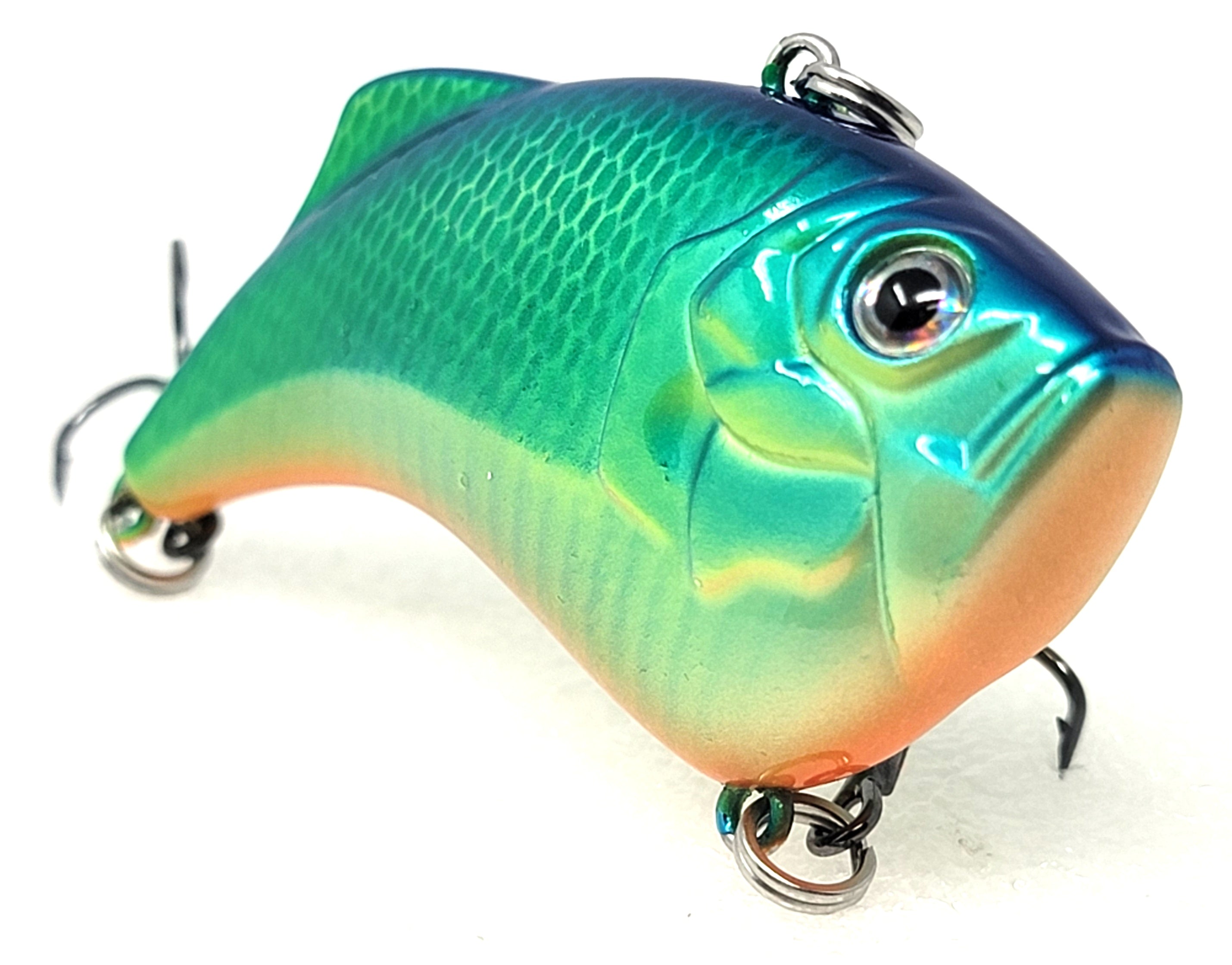 Green and blue fish-shaped fishing lure with treble hooks, detailed scale pattern