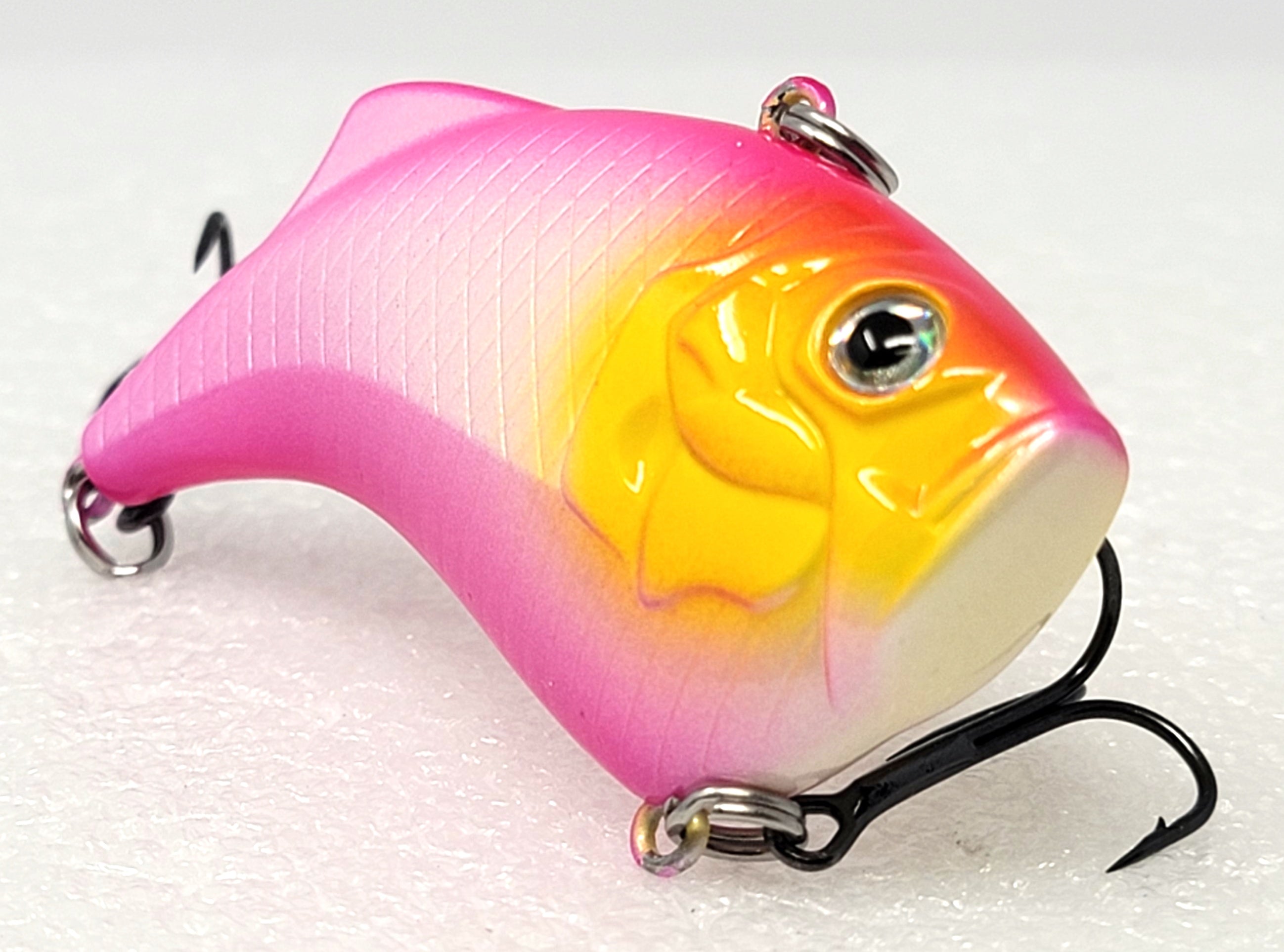 Vibrant pink and yellow fishing lure with dual treble hooks, for outdoor angling gear.
