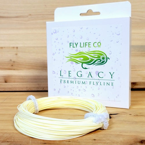 Premium fly fishing line coiled in front of Legacy Fly Life Co packaging on wooden surface