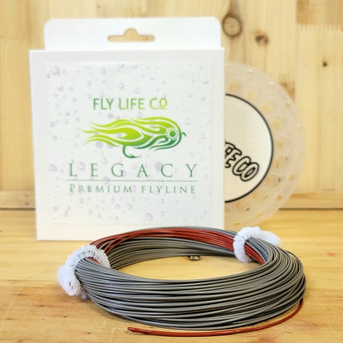 Premium fly fishing line with packaging and spool on wooden surface, fishing gear