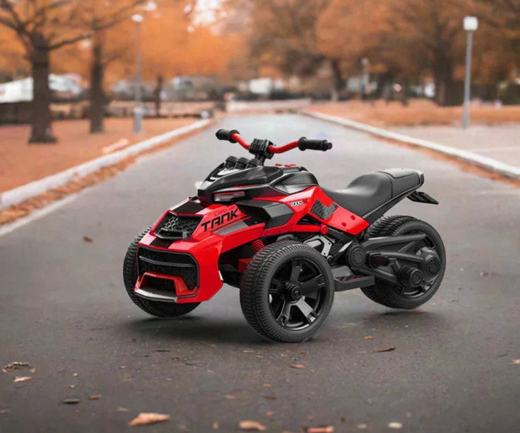 Red and black kids' ride-on toy quad bike on an empty park road in autumn