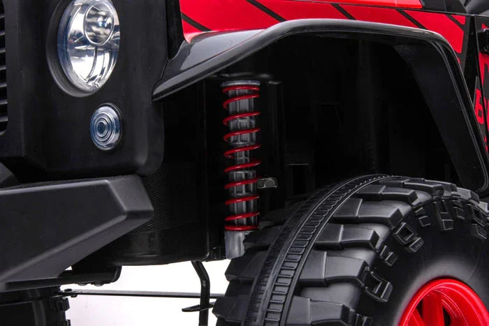 Close-up of off-road vehicle suspension with red coil spring and rugged tire