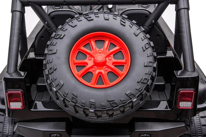 Black toy car rear view with mounted spare tire featuring a red rim, rugged design