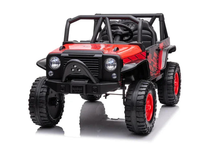 Red and black kids ride-on toy jeep with large off-road tires, front view on white background