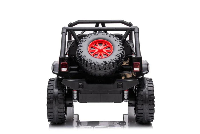 Rear view of black toy off-road jeep with red-rimmed spare tire and rugged tires