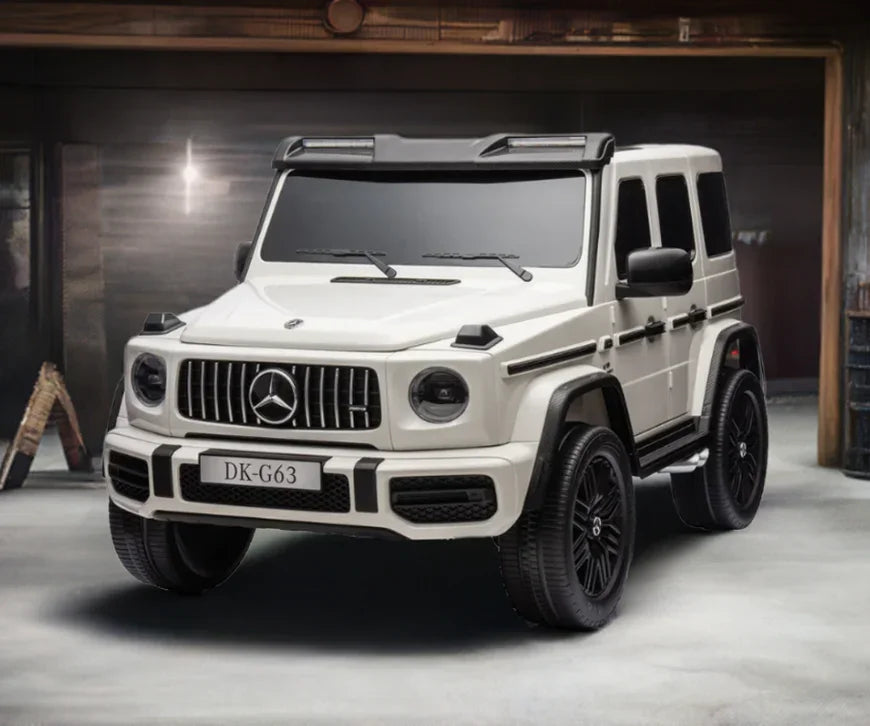 White Mercedes G63 AMG toy car with black wheels in a garage setting