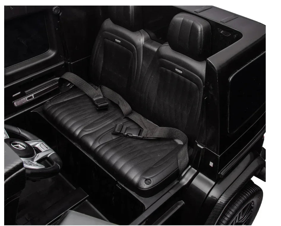 Black leather car interior with seatbelt, rear seats and steering wheel visible