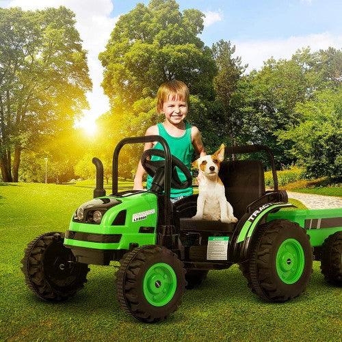 Smiling child and small dog on green toy tractor in sunny park with lush trees