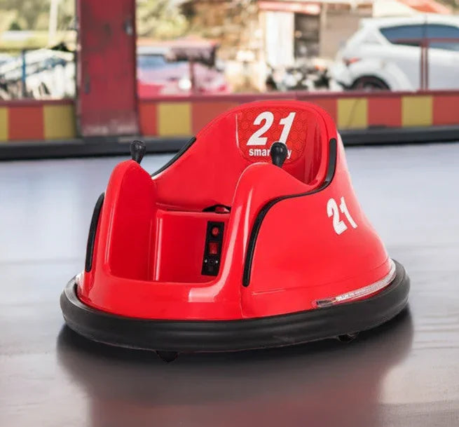 Red kids bumper car ride with number 21 on smooth indoor arena, amusement park setting.