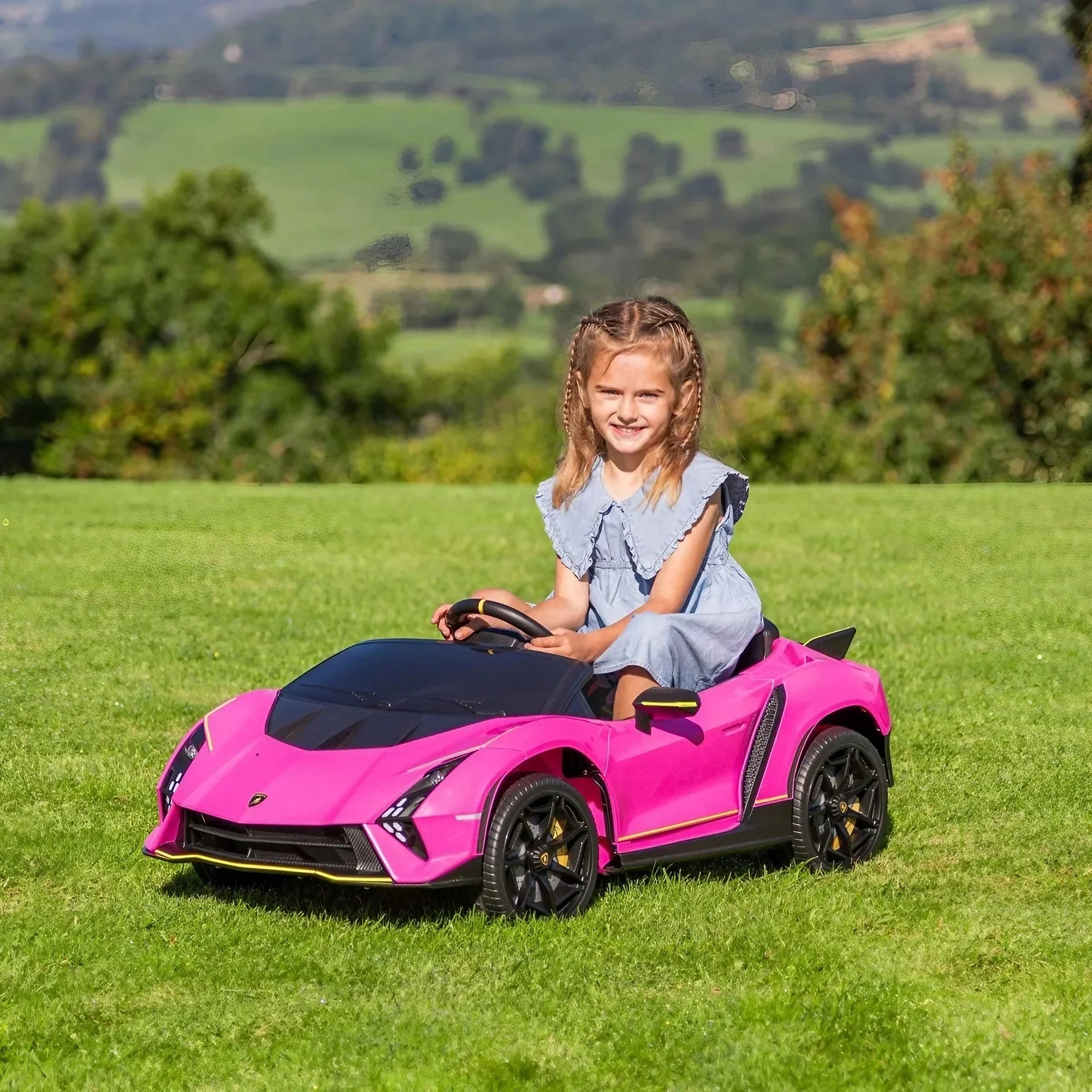 Girl driving pink Lamborghini ride-on toy car on green grass outdoors
