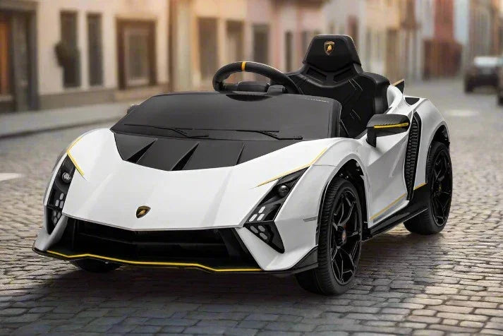 White Lamborghini kids ride-on car with black accents on cobblestone street