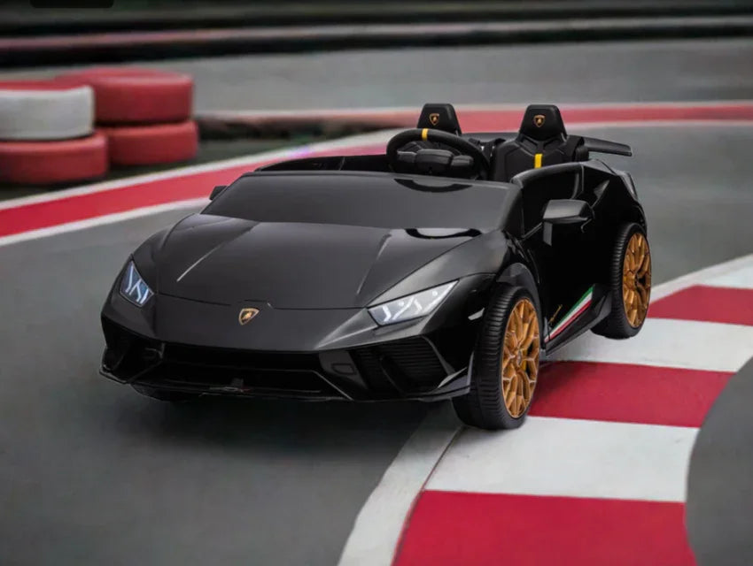 Black kids ride-on Lamborghini toy car with gold wheels on a race track