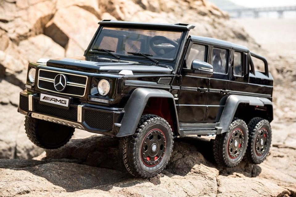 Black Mercedes-AMG G63 6x6 toy truck on rocky outdoor terrain