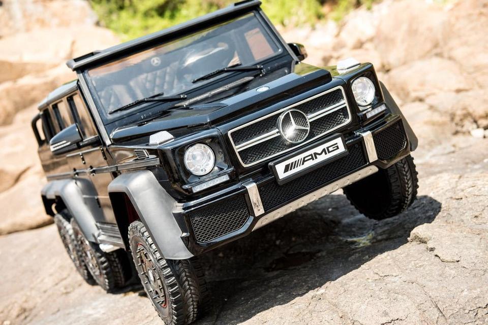 Black Mercedes AMG G63 6x6 RC car climbing rocks outdoors