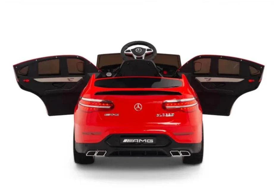 Red Mercedes AMG kids ride-on car with open doors, rear view, white background