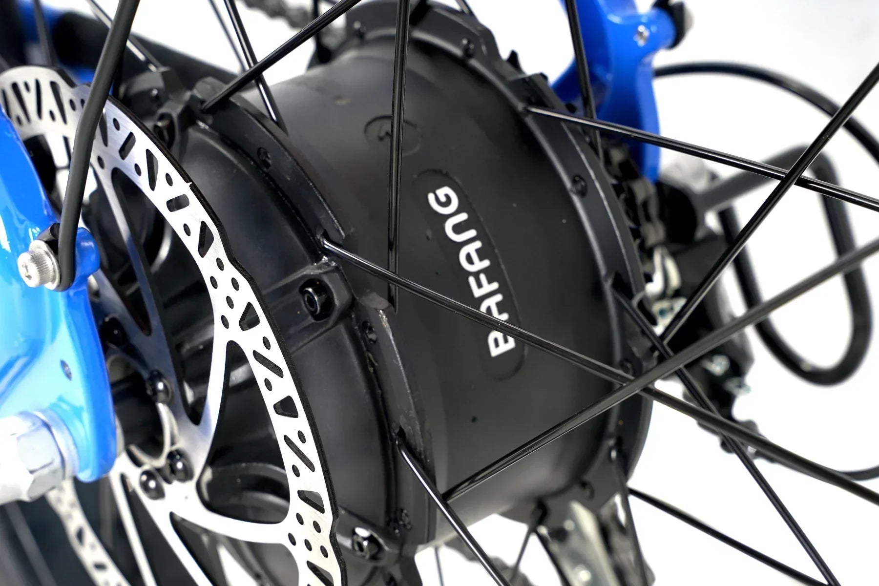 Close-up of Bafang electric bike hub motor and disc brake on blue Taubik Tour bicycle.