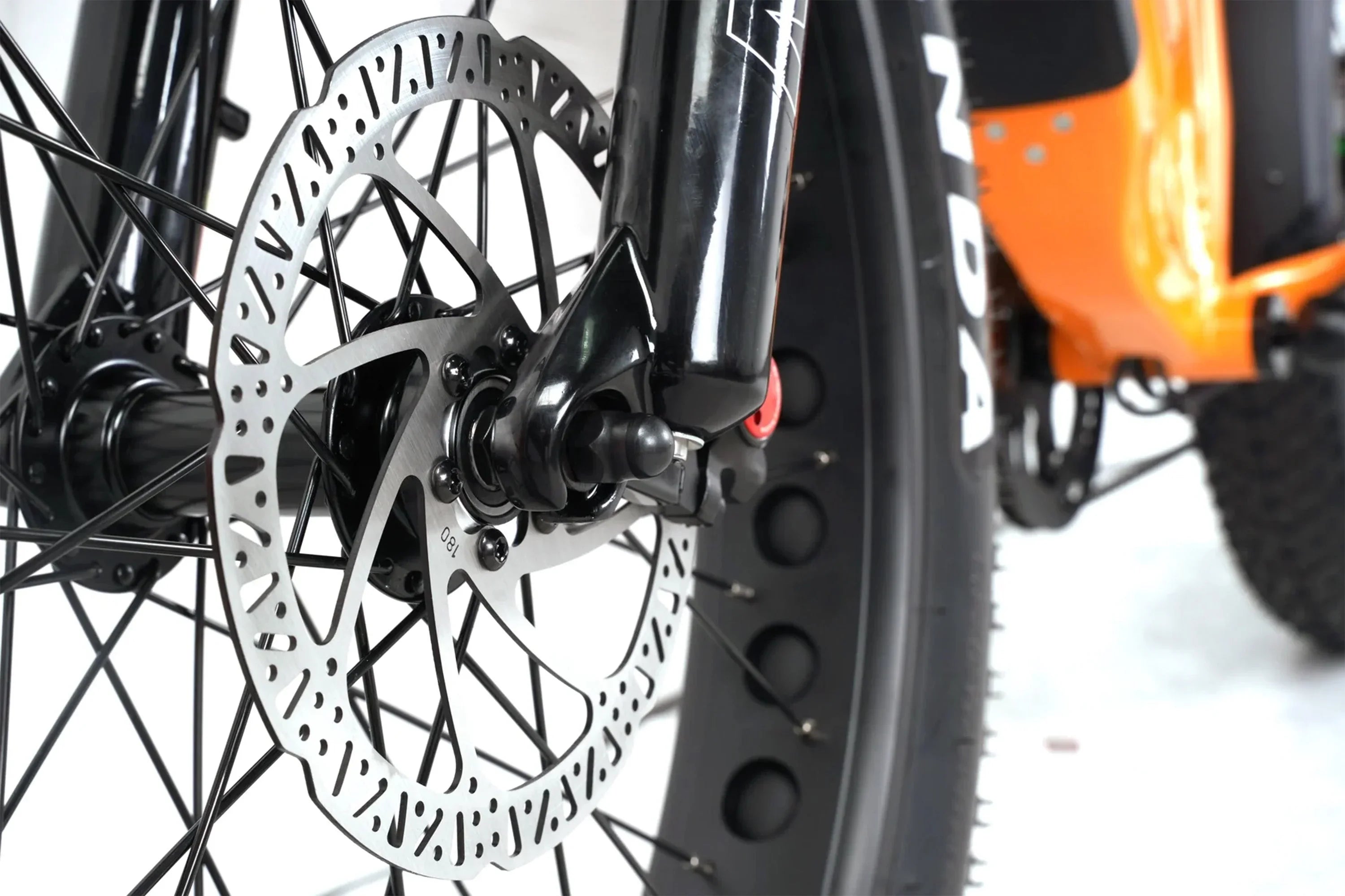 Close-up of Taubik Westridge 4T off-road e-bike front wheel with disc brake