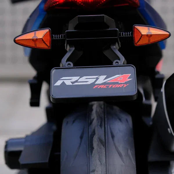 Rear view of a blue Aprilia RSV4 Factory motorcycle with taillights and wide rear tire