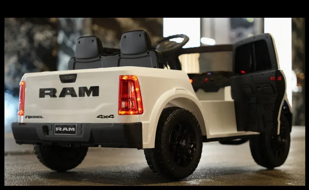 White toy RAM Rebel 4x4 truck with open door, black seats, and red tail lights