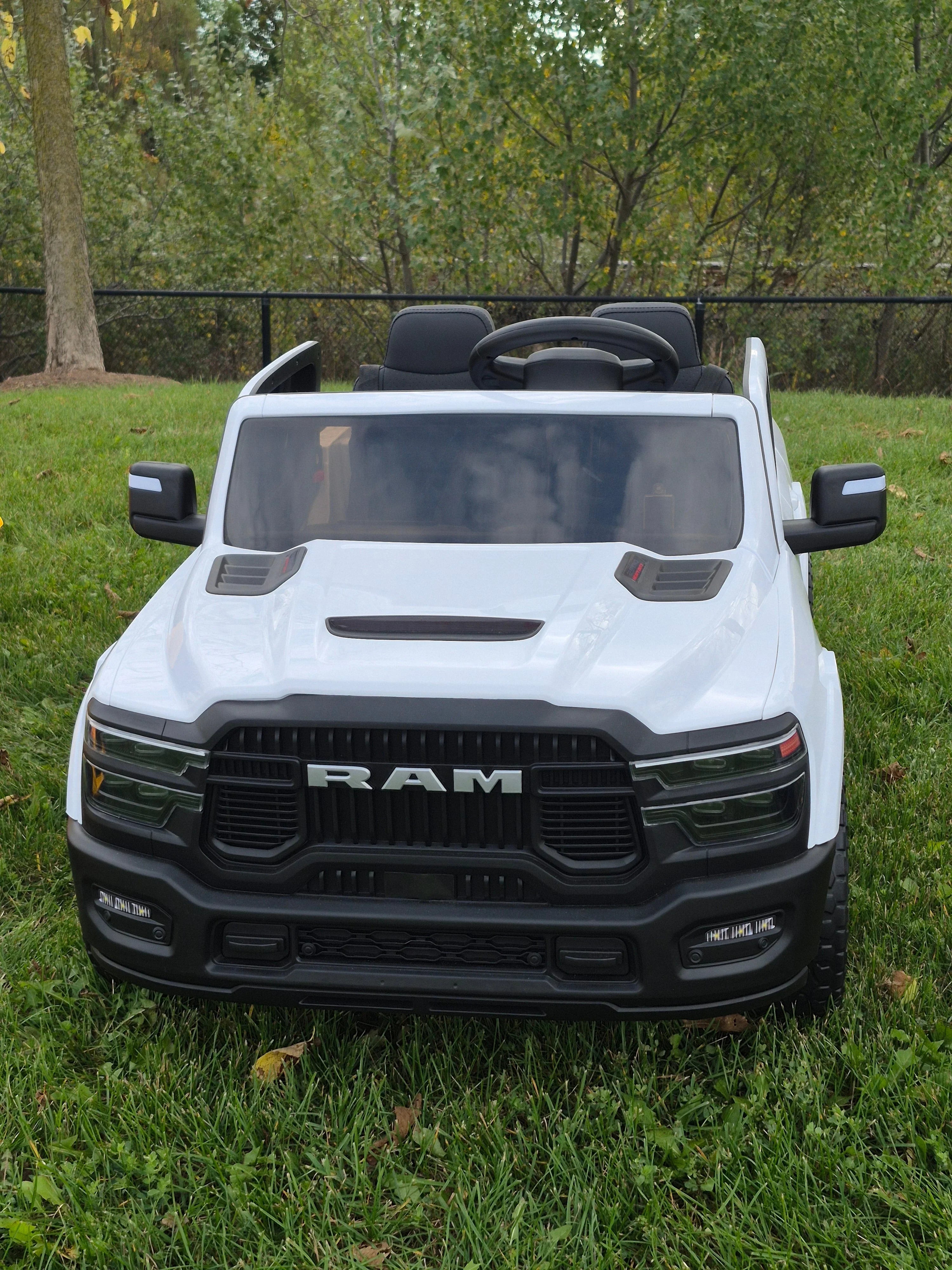 White RAM toy truck for kids on green grass with trees in the background