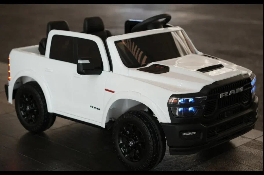 White toy RAM truck ride-on car with LED lights on black floor