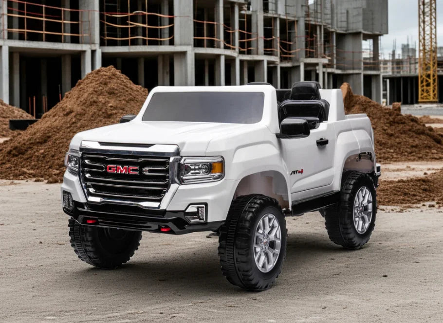 White GMC toy truck parked on construction site with dirt piles and building framework
