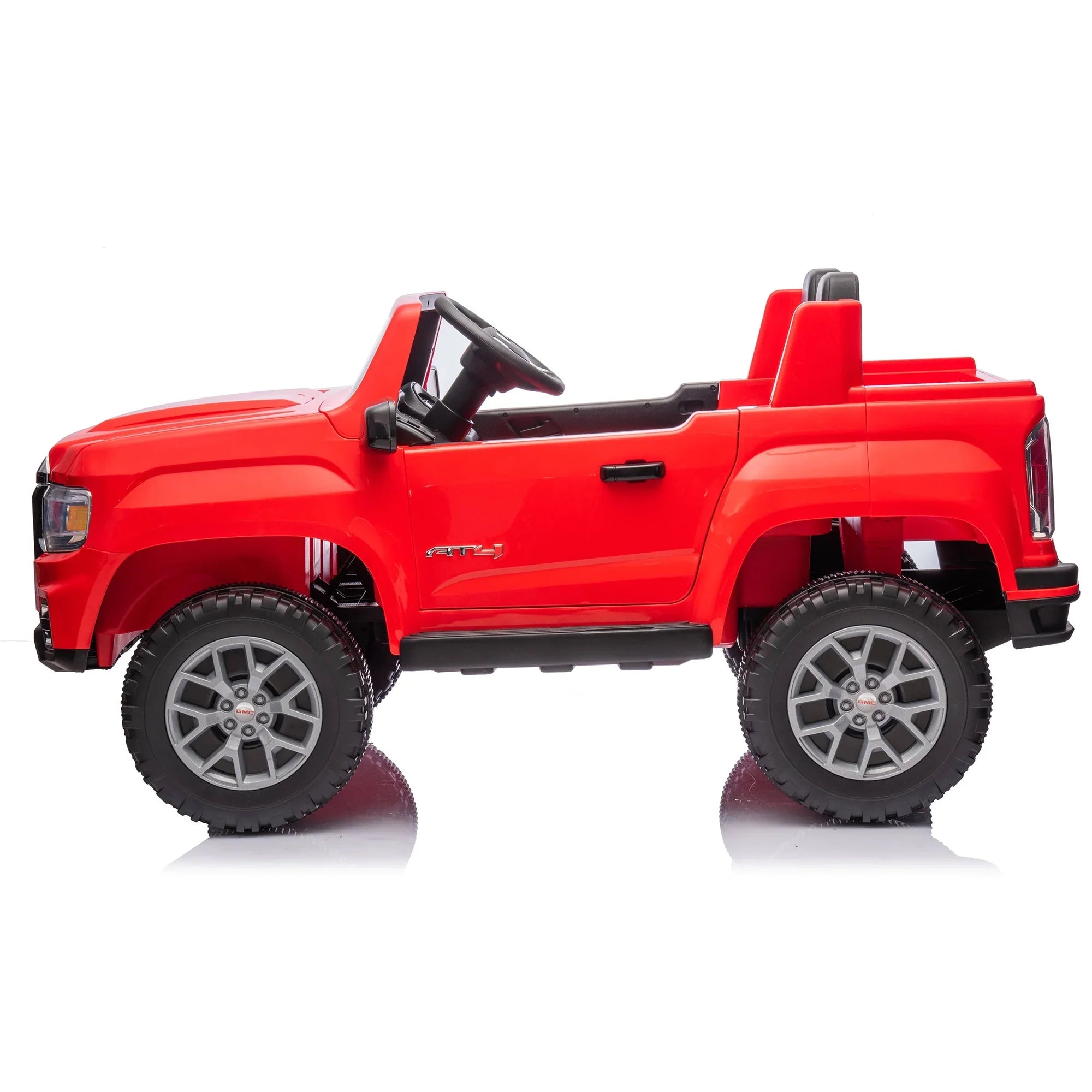 Red kids ride-on toy truck with large wheels and black seats on a white background